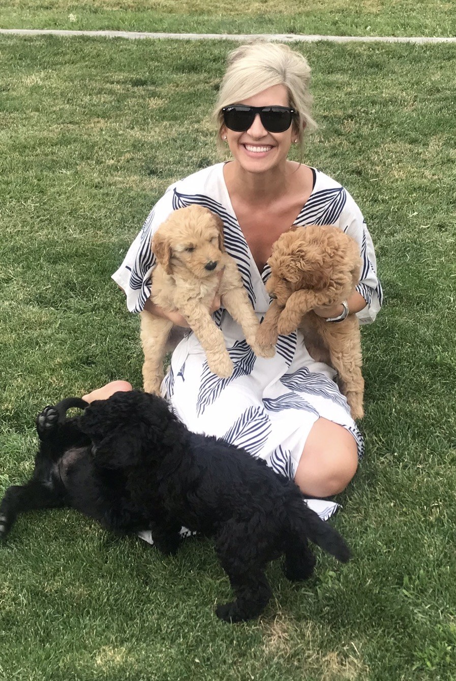 Stefanie outdoors surrounded by dogs